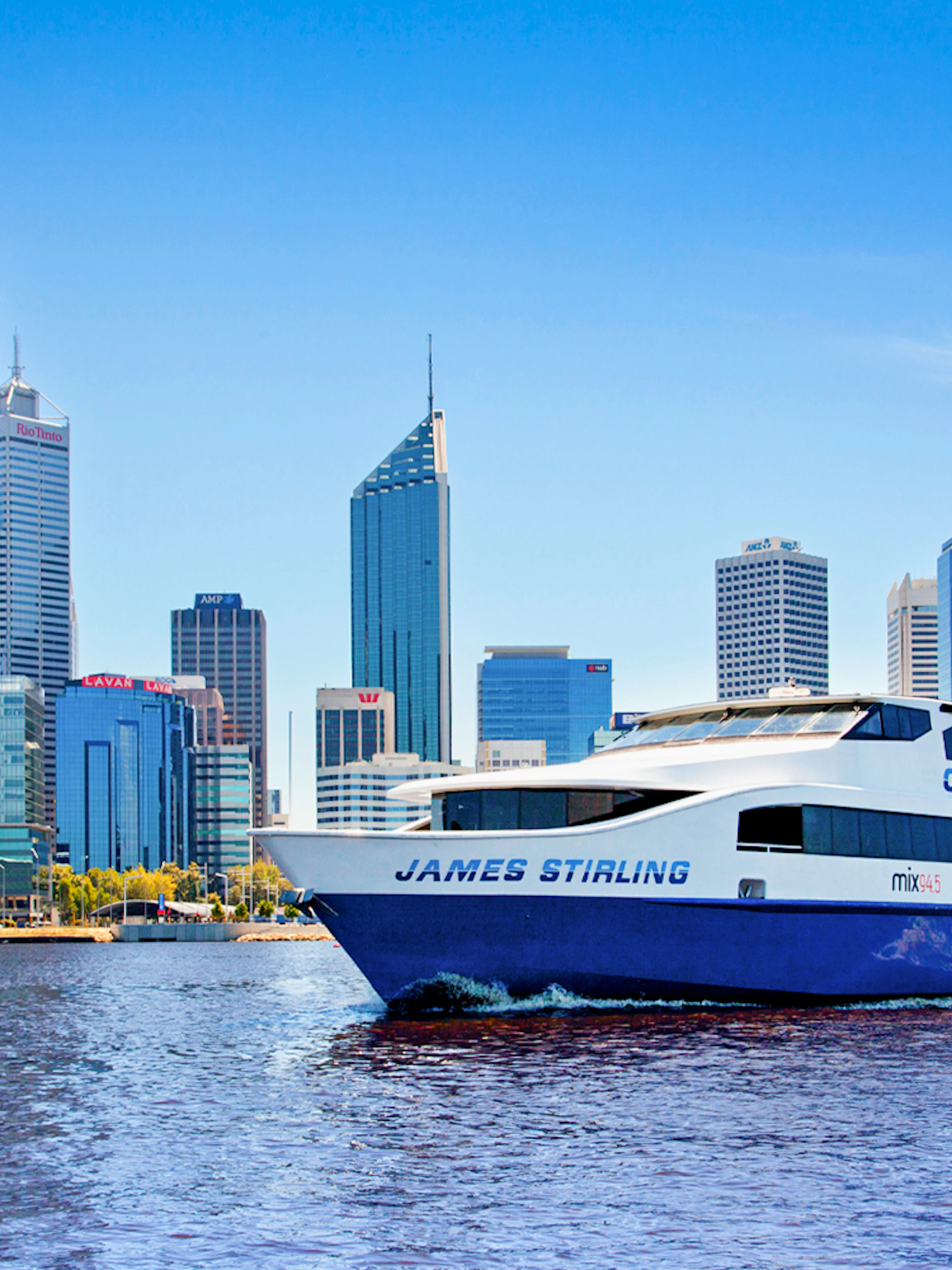 Cruise boat on Swan River with Perth skyline in the background.