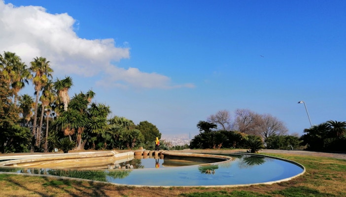 Montjuïc hill view with tourists on a guided walking tour in Barcelona, Spain.