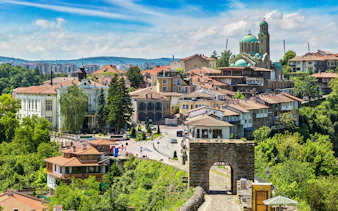 Tsarevets Fortress entrance with Veliko Tarnovo cityscape in the background, Bulgaria.