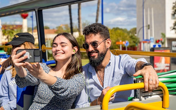 People taking a selfie on a Seville hop-on hop-off bus tour.