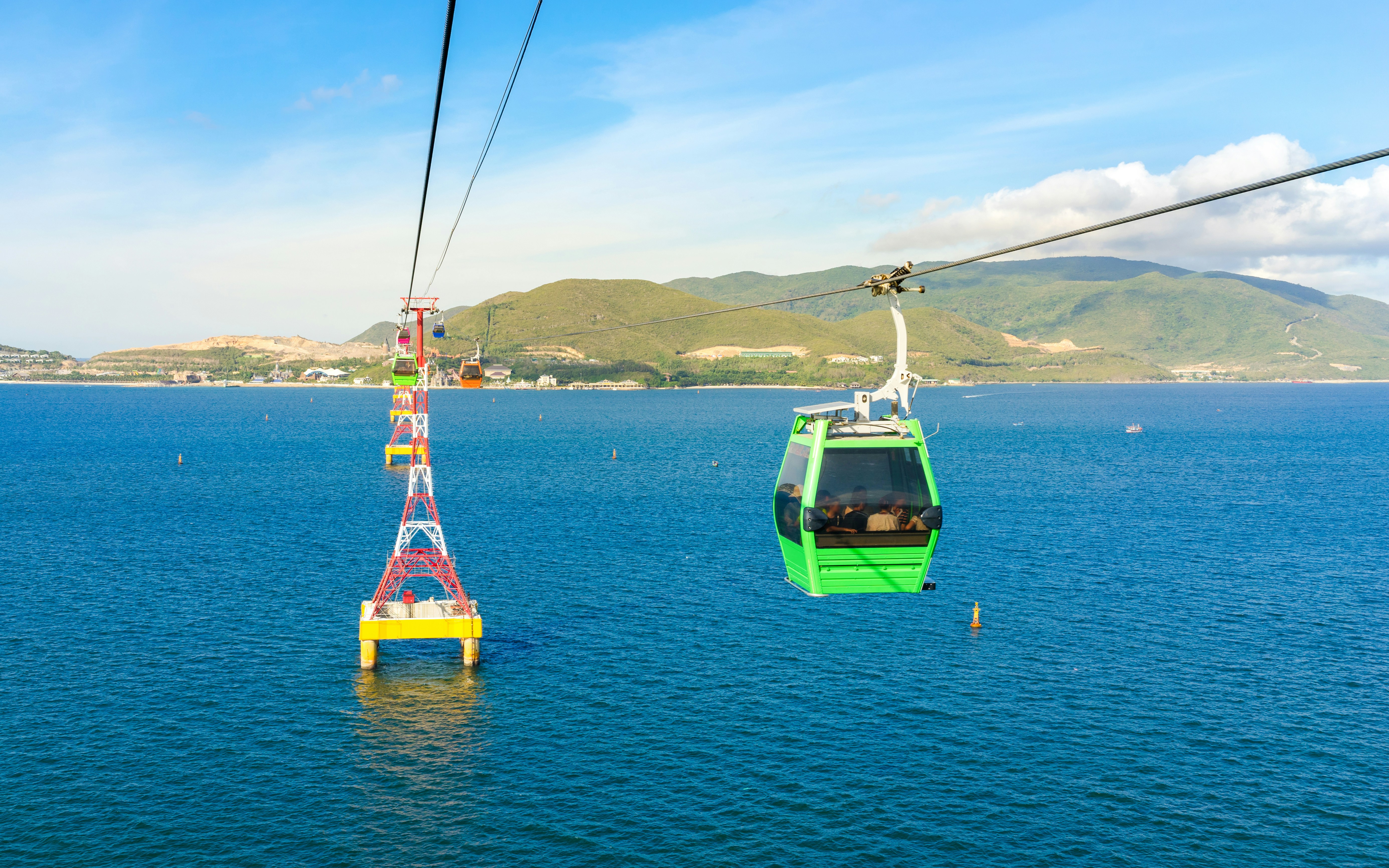 Vinpearl Cable Car over ocean with mountains in Nha Trang, Vietnam.