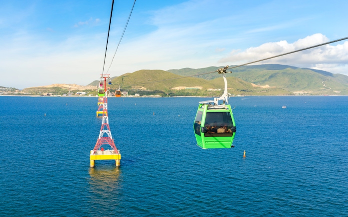 Vinpearl Cable Car over ocean with mountains in Nha Trang, Vietnam.