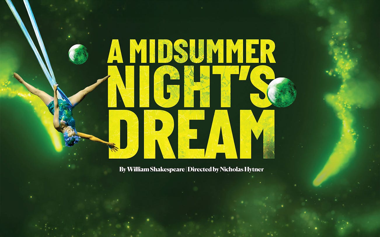 Aerial performer in "A Midsummer Night's Dream" with green backdrop.