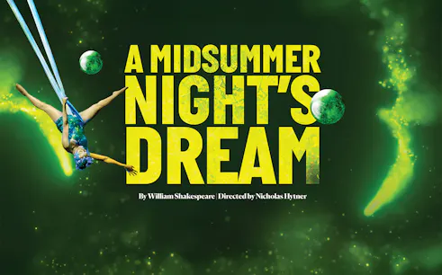 Aerial performer in "A Midsummer Night's Dream" with green backdrop.