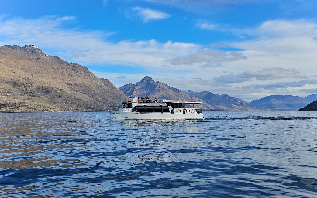 Cruise boat on Lake Wakatipu with mountain backdrop, Queenstown.