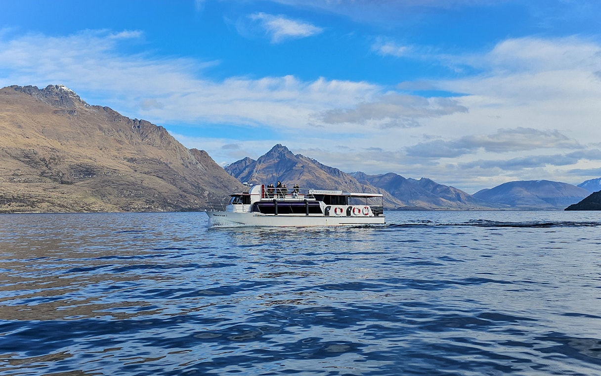 Cruise boat on Lake Wakatipu with mountain backdrop, Queenstown.