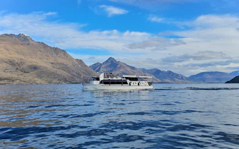 Cruise boat on Lake Wakatipu with mountain backdrop, Queenstown.