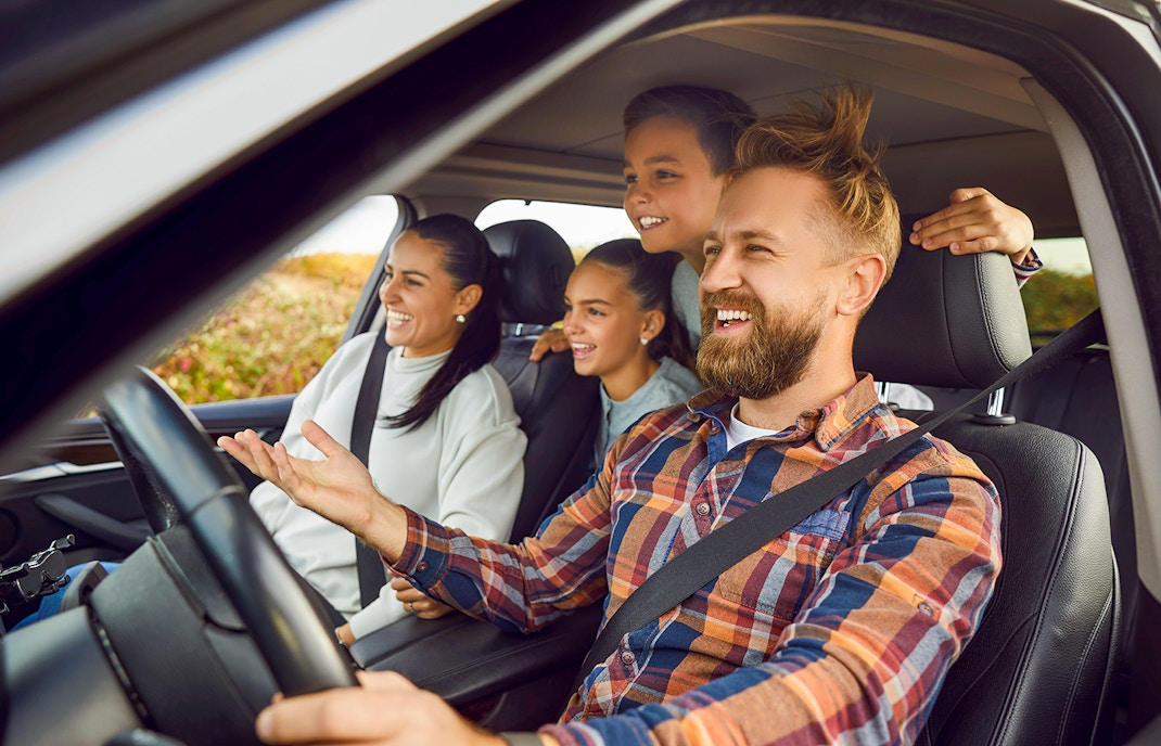 Family driving on scenic road trip through countryside
