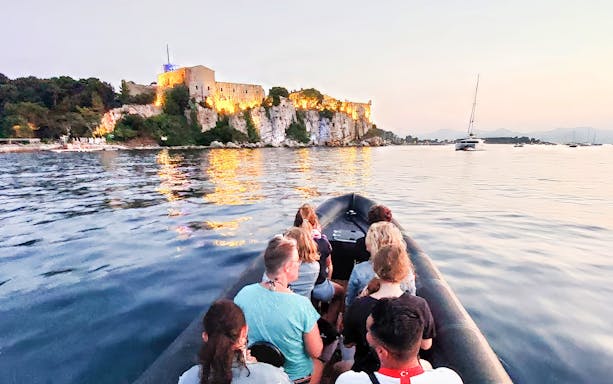 Boat tour with view of illuminated Vauban Fort in the evening, Antibes.