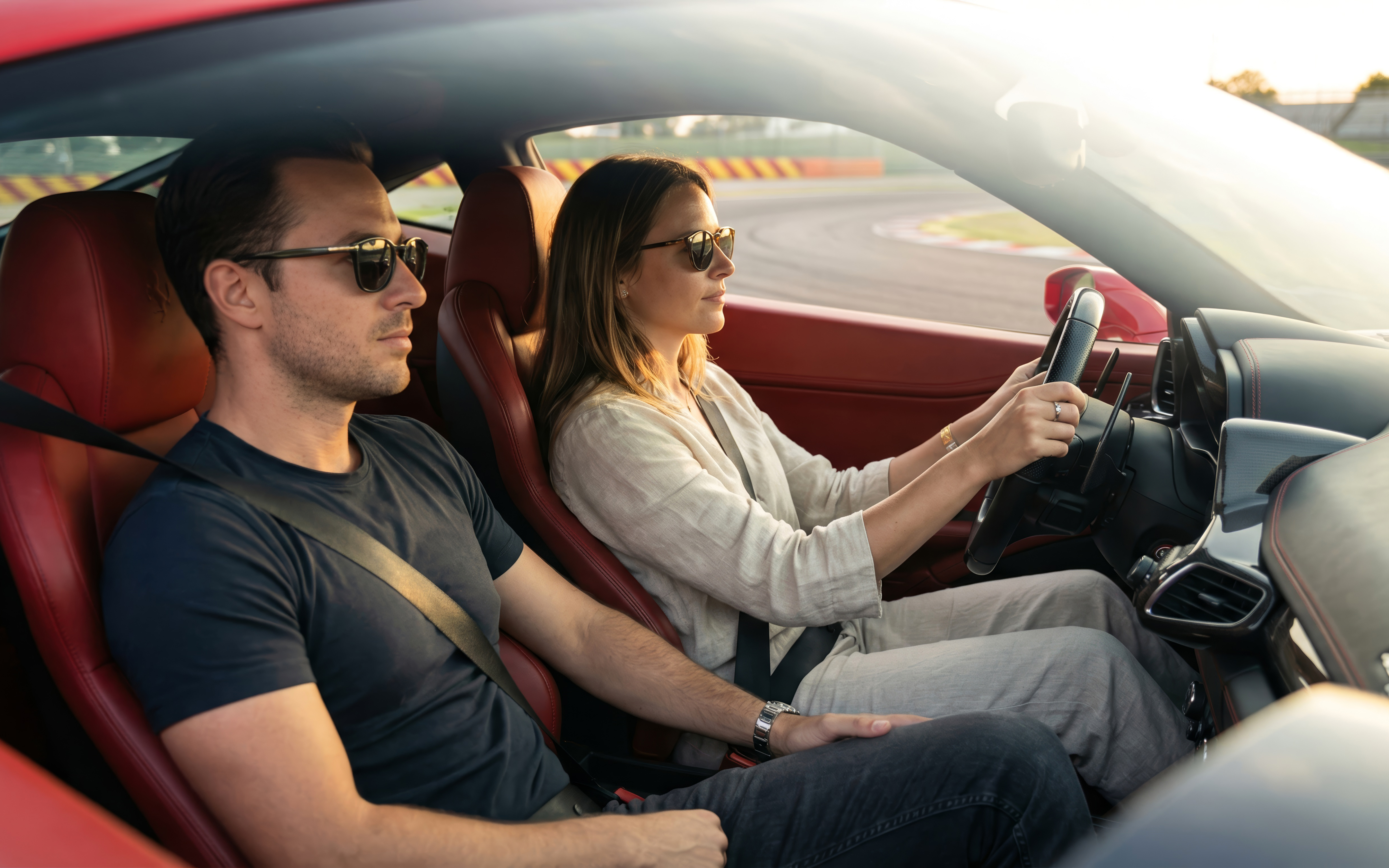 Woman driving a Ferrari 458 at Maranello Ferrari Museum track.