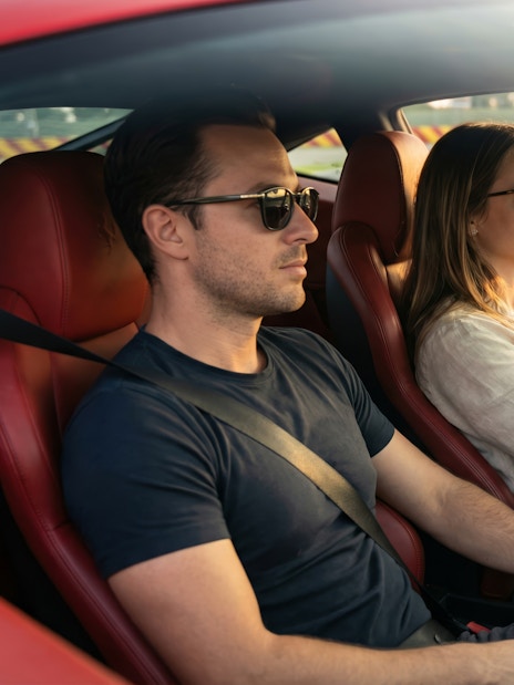 Woman driving a Ferrari 458 at Maranello Ferrari Museum track.