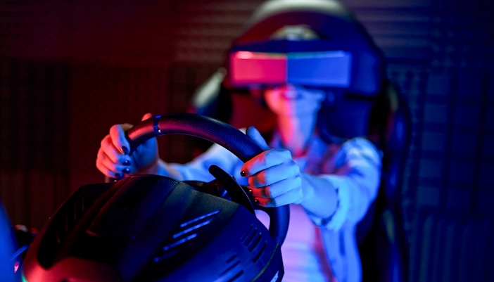 Person using Ferrari GT Simulator at Ferrari Museum.