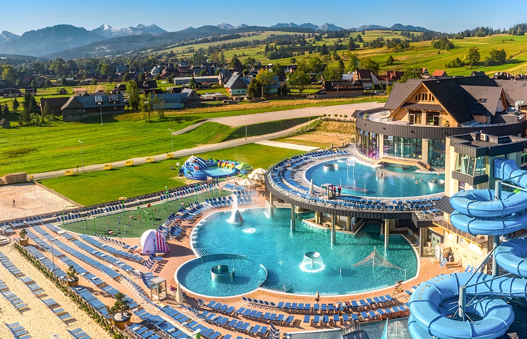 Tourists relaxing in Zakopane thermal spa, with cable car ride and Krakow hotel transfers.