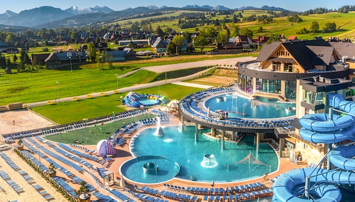 Tourists relaxing in Zakopane thermal spa, with cable car ride and Krakow hotel transfers.
