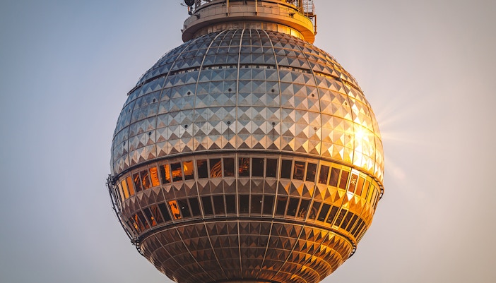 Berlin TV Tower close-up at sunset, highlighting the observation deck.