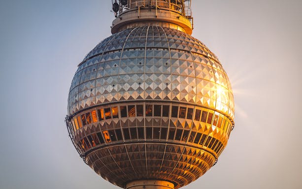 Berlin TV Tower close-up at sunset, highlighting the observation deck.