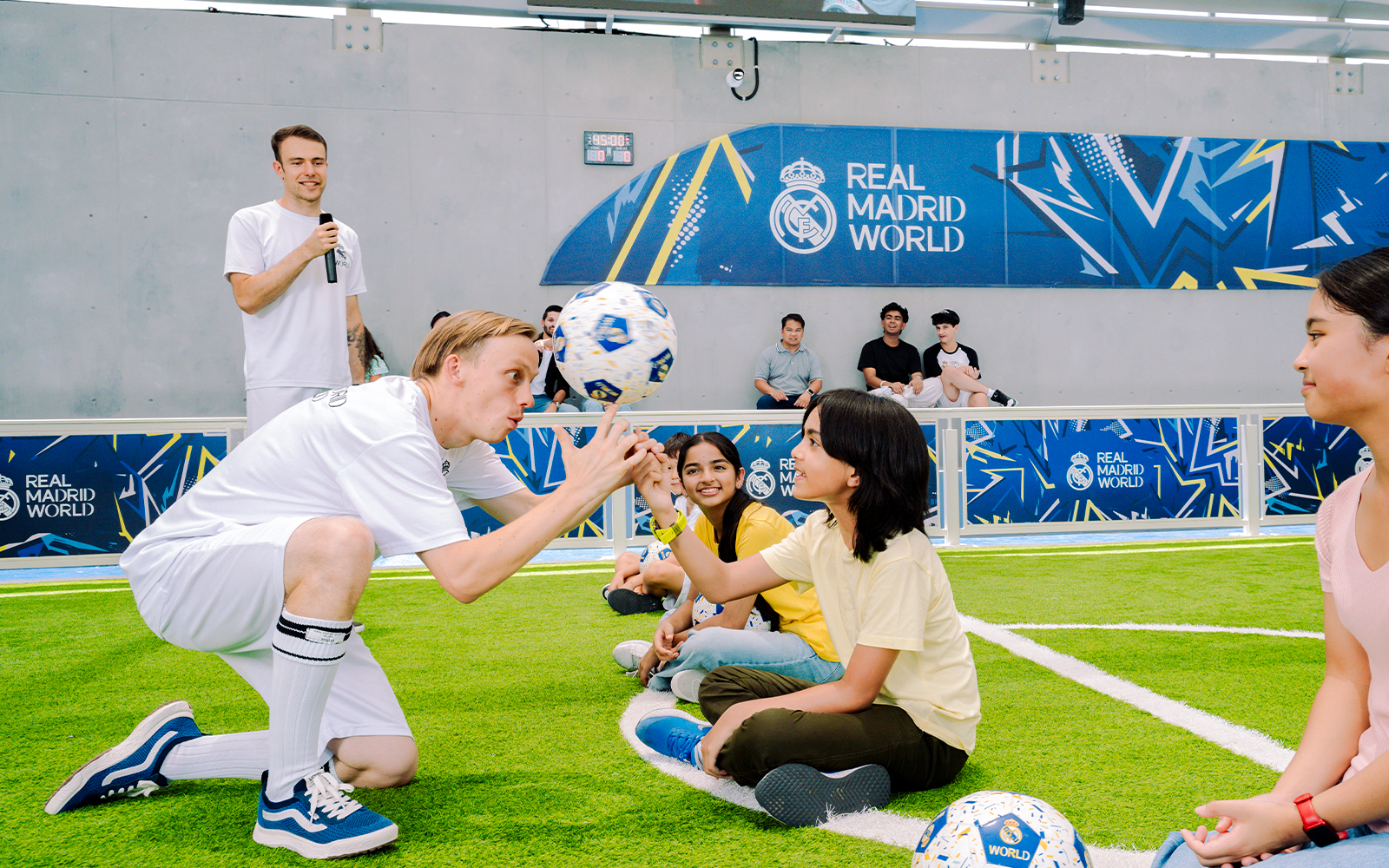 Kids learning football skills at Real Madrid World training session.