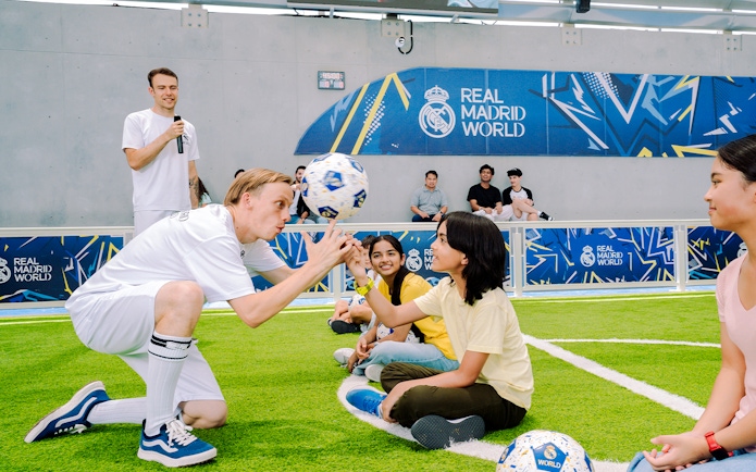 Kids learning football skills at Real Madrid World training session.