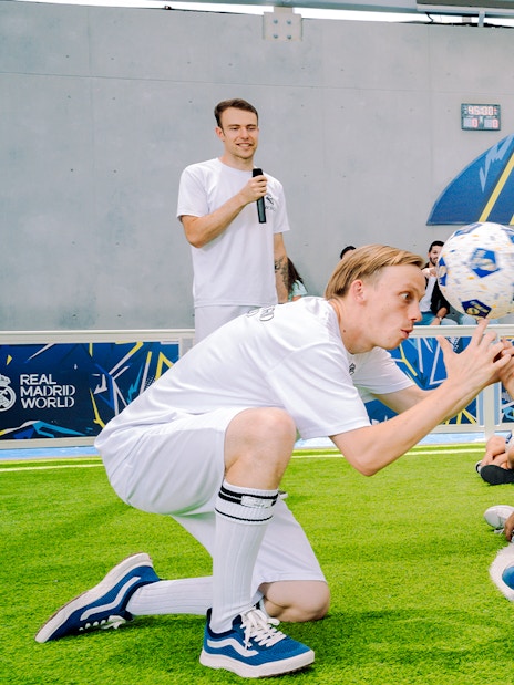 Kids learning football skills at Real Madrid World training session.