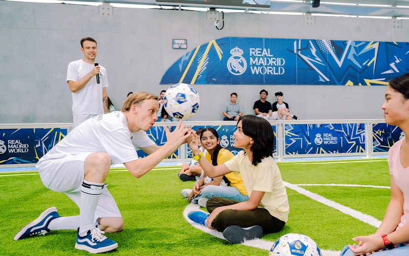 Kids learning football skills at Real Madrid World training session.