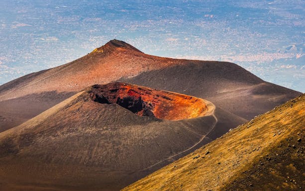 Mount Etna cable car ascending with trekkers exploring volcanic landscape in Catania, Sicily.