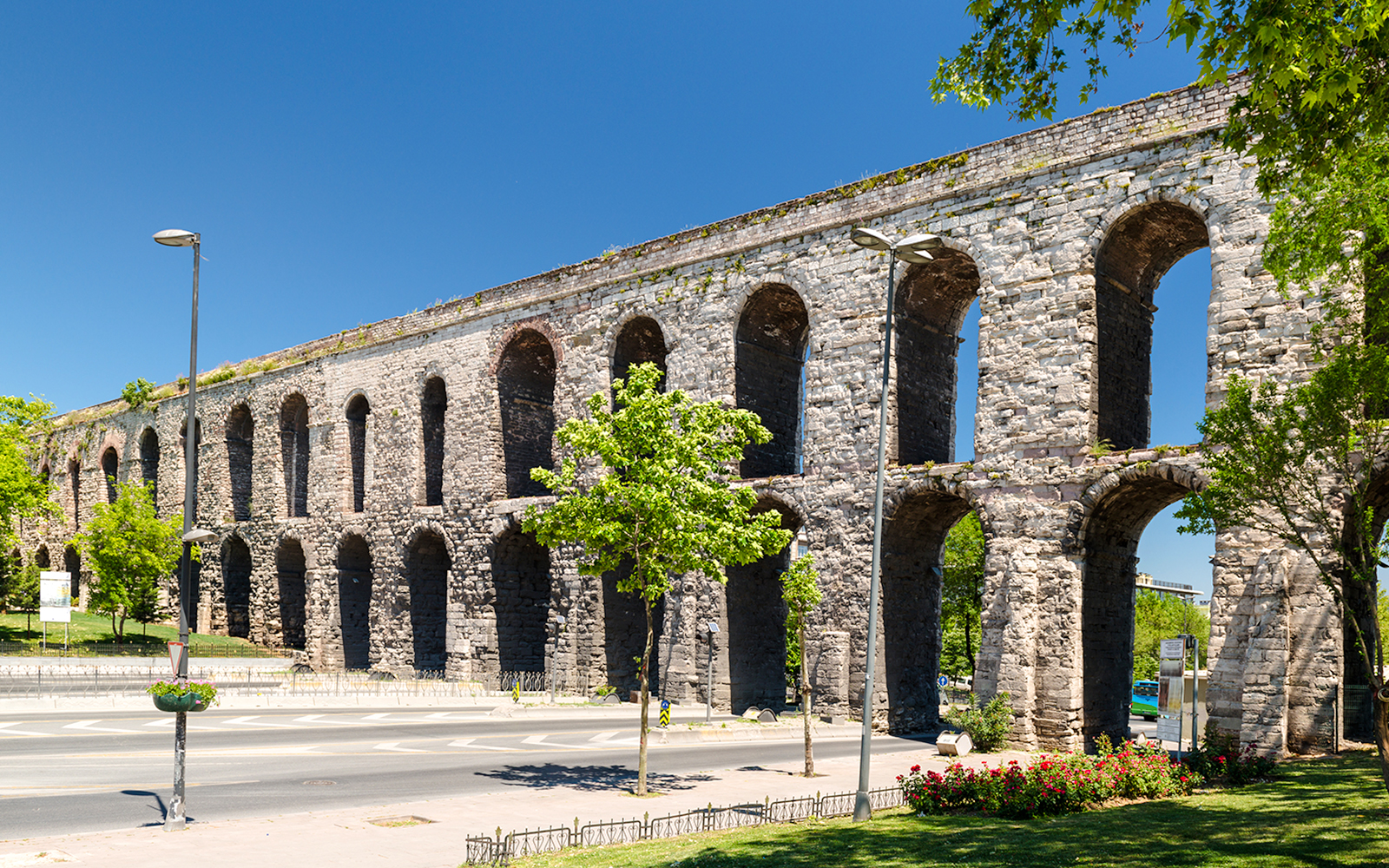Aqueduct of Valens in Istanbul, Turkey with stone arches and surrounding greenery.