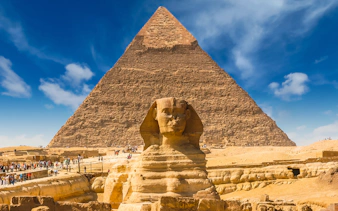 Giza Pyramids and Sphinx with tourists in Cairo, Egypt.