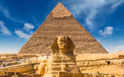 Giza Pyramids and Sphinx with tourists in Cairo, Egypt.
