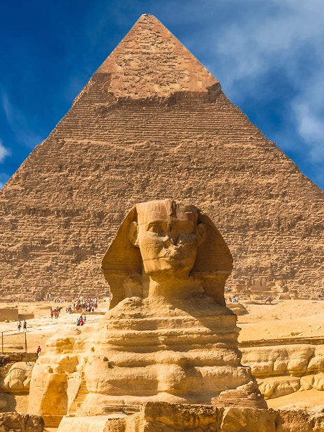 Giza Pyramids and Sphinx with tourists in Cairo, Egypt.