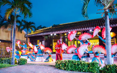 Performers with red fans at Hoi An Memories Show, Vietnam.