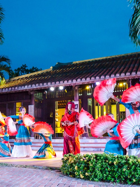 Performers with red fans at Hoi An Memories Show, Vietnam.