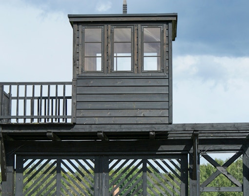 Stutthof concentration camp entrance with historical exhibits, part of Warsaw tour including lunch.