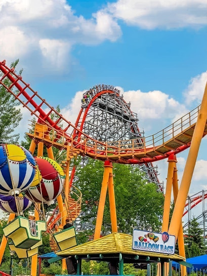 Flashback Rollercoaster at Six Flags New England with colorful balloon ride in foreground.