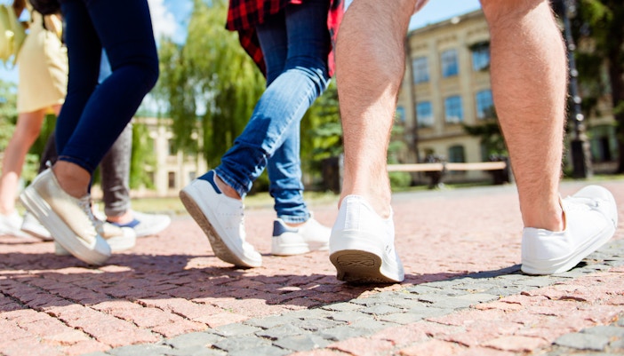 Group of friends walking outside near historical landmarks in Rome, Italy.