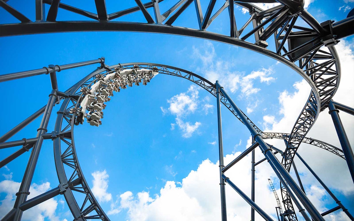 Roller coaster loop at Movie Park Germany against blue sky.