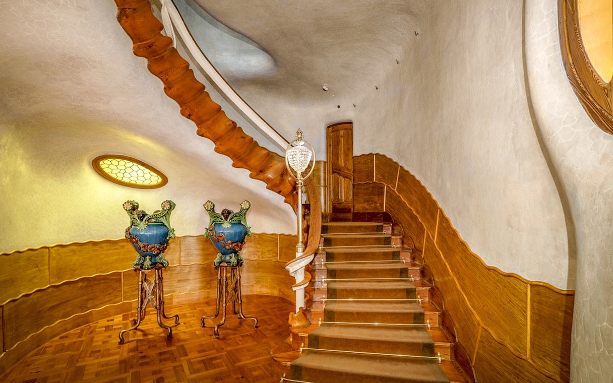 Casa Batlló interior staircase with ornate vases, Barcelona.