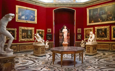 Tourists viewing sculptures and paintings in the Uffizi Gallery, Florence, Italy.