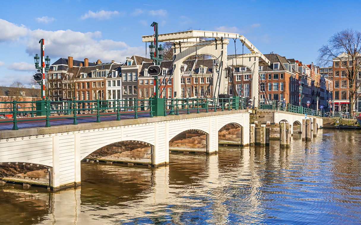 Magere Brug over Amstel River with canal houses in Amsterdam.