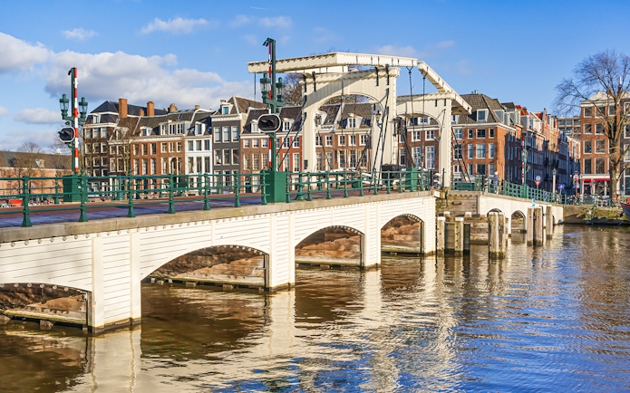 Magere Brug over Amstel River with canal houses in Amsterdam.