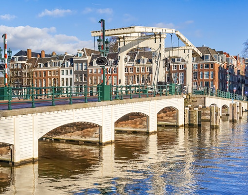 Magere Brug over Amstel River with canal houses in Amsterdam.