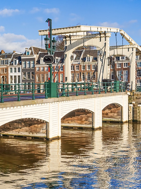 Magere Brug over Amstel River with canal houses in Amsterdam.