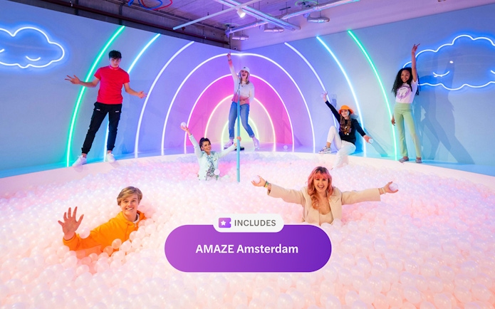 Visitors enjoying a colorful ball pit at AMAZE Amsterdam, part of Go City Amsterdam Explorer Pass.