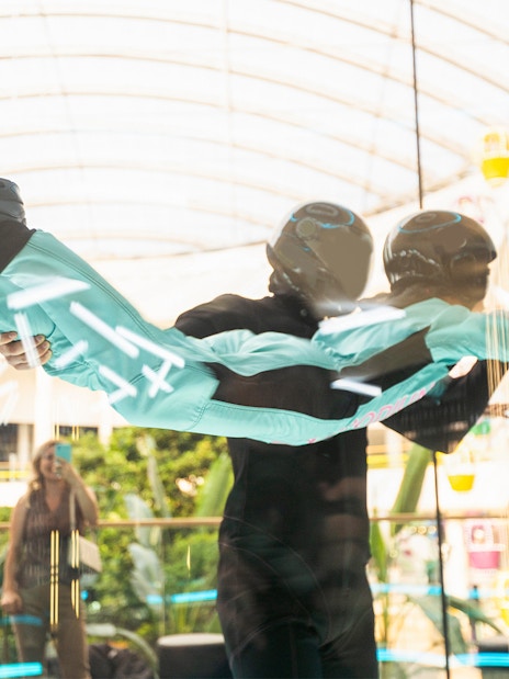 Young girl with instructor in iFly Dubai indoor skydive experience.