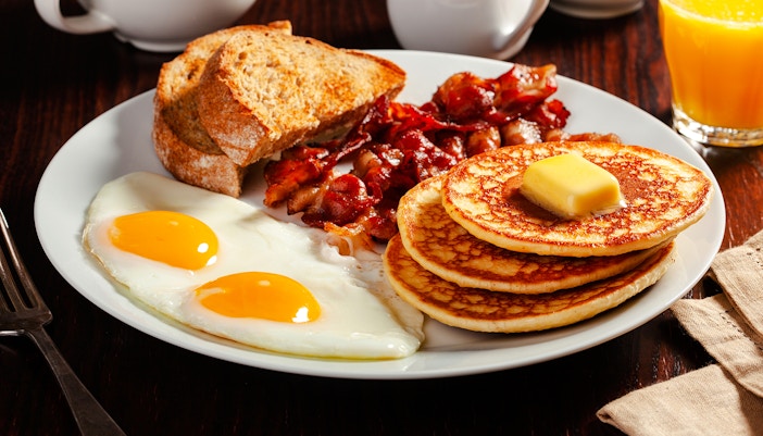 traditional full canadian breakfast eggs pancakes with bacon and toast