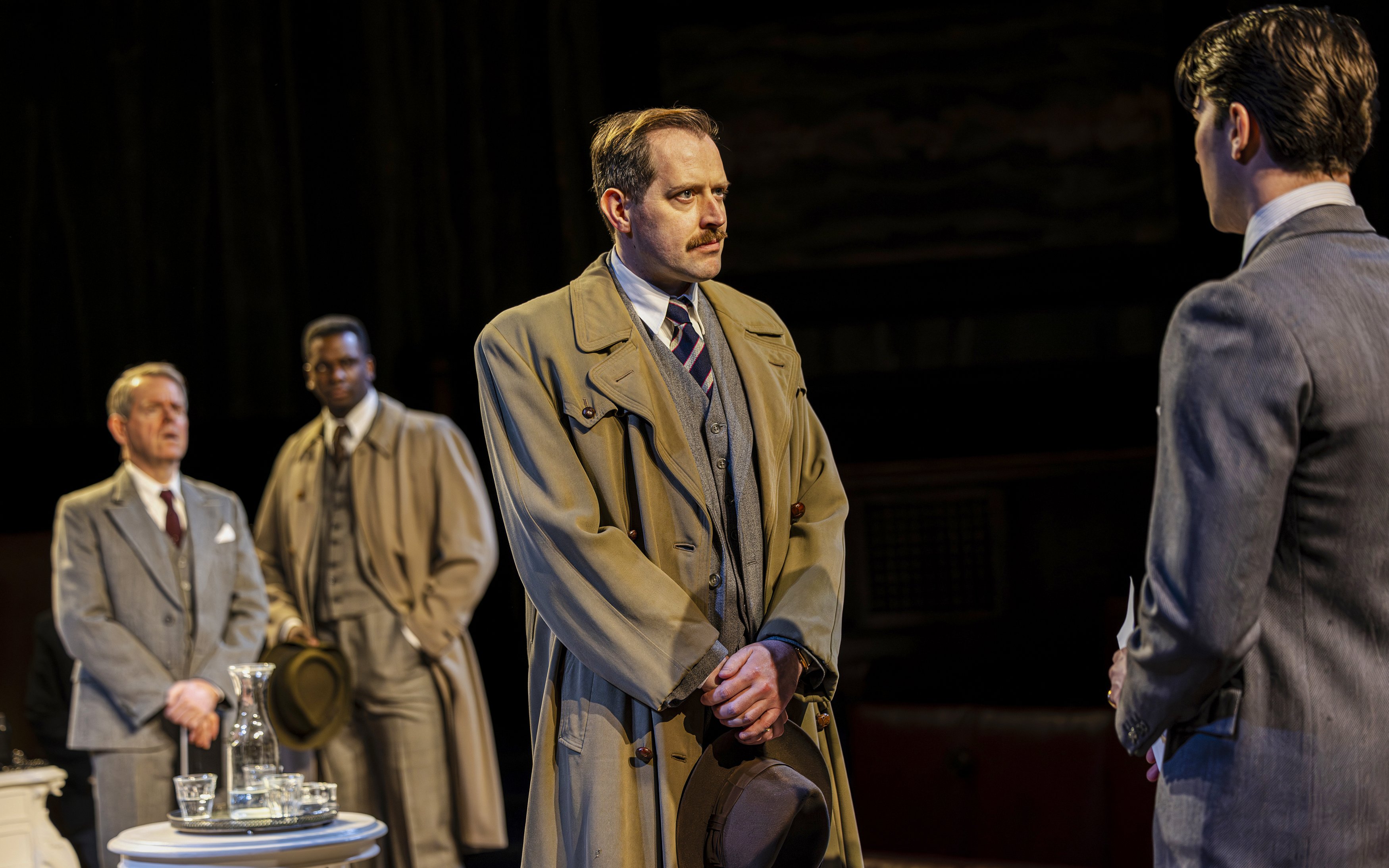 Cast of "Witness for the Prosecution" in courtroom attire during West End show.