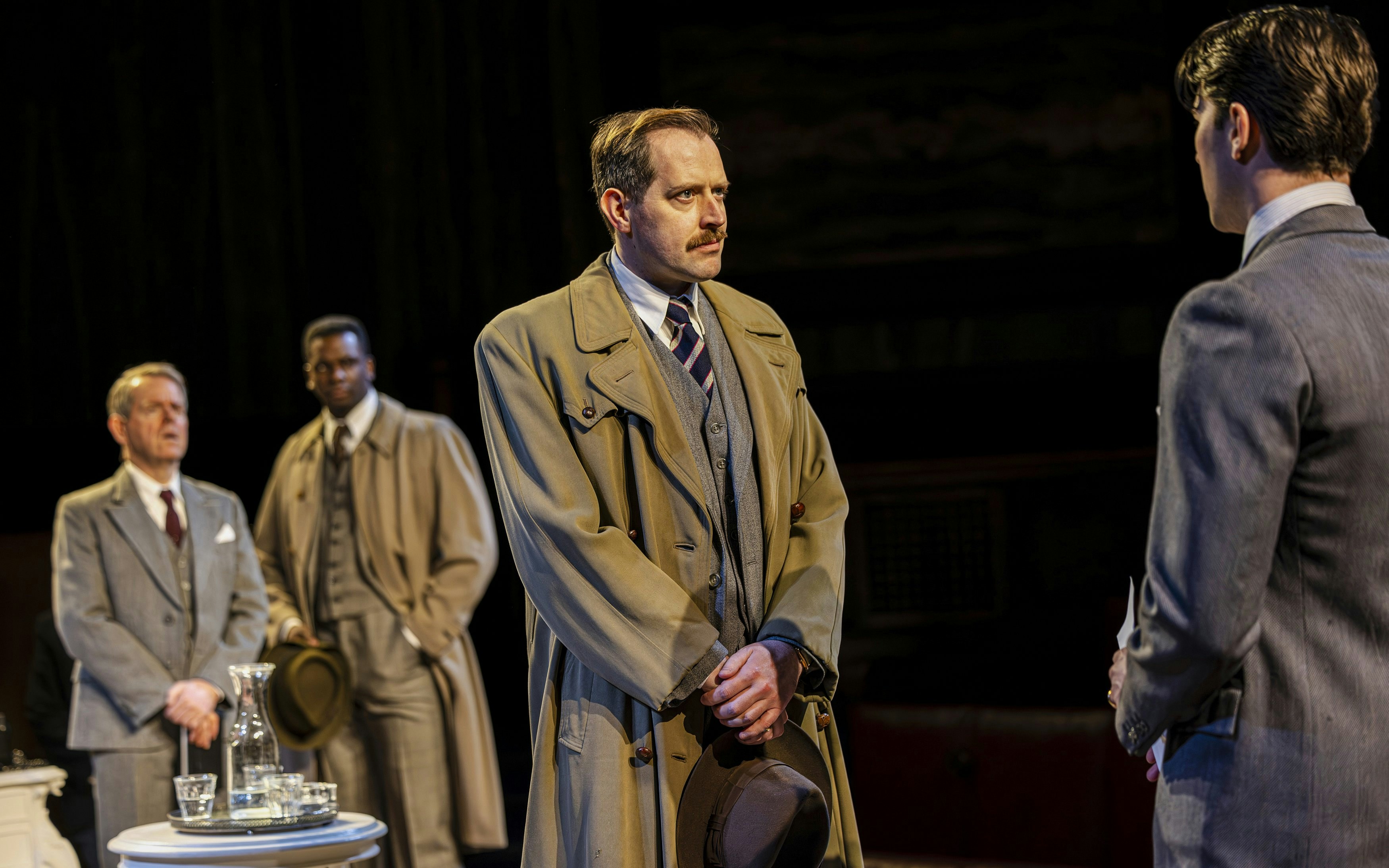 Cast of "Witness for the Prosecution" in courtroom attire during West End show.