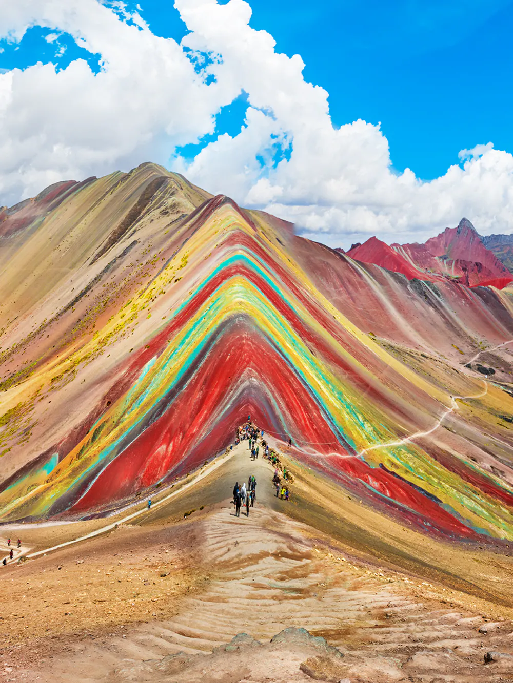 Hikers on trail at Rainbow Mountain, Vinicunca, Cusco Region, Peru.