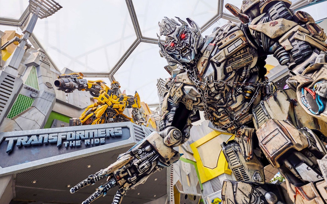 Transformers ride entrance at Universal Studios Singapore featuring robot statues.