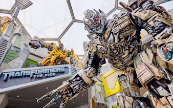 Transformers ride entrance at Universal Studios Singapore featuring robot statues.