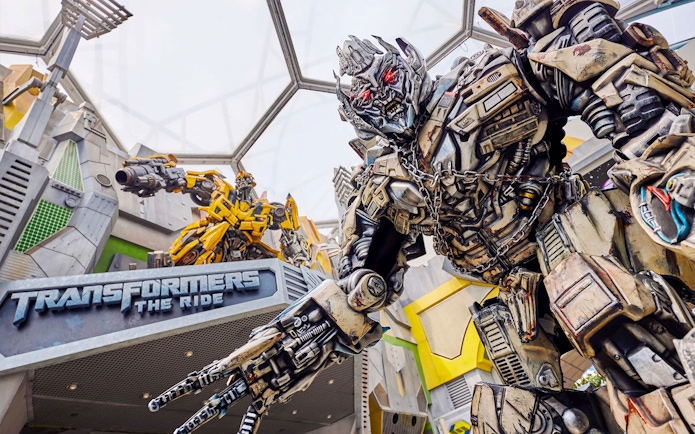 Transformers ride entrance at Universal Studios Singapore featuring robot statues.